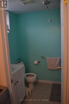 Mississauga (Lakeview) apartment for rent - A bathroom with a toilet, sink, and towel rack.
