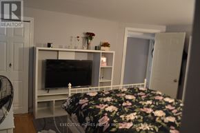 Mississauga (Lakeview) apartment for rent - A bedroom with a bed, a television, and a fan.