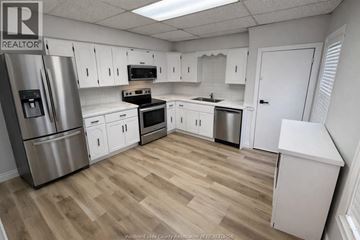Windsor apartment for rent - A kitchen with white cabinets and a wooden floor.