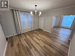 Windsor apartment for rent - A room with wooden flooring and a chandelier.