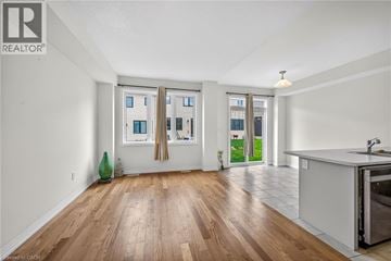 Caledonia townhouse for rent - A kitchen area with a sink and a window with curtains.