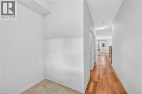 Caledonia townhouse for rent - A long hallway with a wooden floor and white walls.