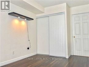 Toronto (Willowdale East) condo for rent - A room with a sliding door and a wall-mounted light fixture.