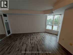 Toronto (Newtonbrook East) condo for rent - A room with wooden flooring and a large window.