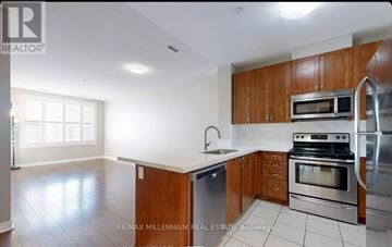 Markham (Middlefield) condo for rent - A kitchen with wooden cabinets and stainless steel appliances.