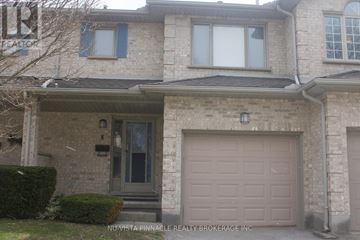 London North (North H) townhouse for rent - A house with a brown garage door is for sale.
