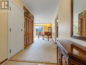 Toronto (Woburn) apartment for rent - A hallway with a wooden floor and a mirror on the wall.