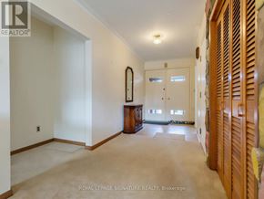 Toronto (Woburn) apartment for rent - A spacious room with a large mirror and wooden furniture.