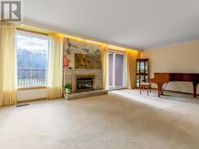 Toronto (Woburn) apartment for rent - A spacious living room with a fireplace and a painting on the wall.