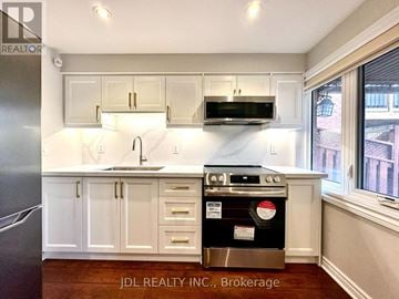 Vaughan (Maple) apartment for rent - A kitchen with white cabinets and a stainless steel oven.