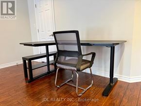 Vaughan (Maple) apartment for rent - A black chair and table with a black base is in a room.