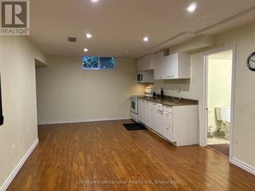Guelph (Clairfields/Hanlon Business Park) apartment for rent - A kitchen with white cabinets and a wooden floor.
