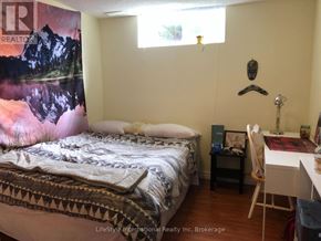 Guelph (Clairfields/Hanlon Business Park) apartment for rent - A bedroom with a bed, desk, chair, and a poster on the wall.
