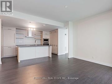 Toronto (Mount Pleasant West) condo for rent - A spacious kitchen with white cabinets and a wooden floor.