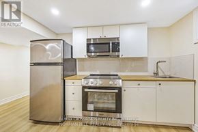 Toronto (Tam O'shanter-Sullivan) apartment for rent - A kitchen with a stainless steel refrigerator, microwave, oven, and sink.