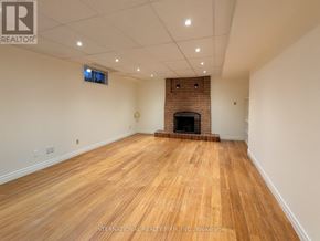 Vaughan (Crestwood-Springfarm-Yorkhill) apartment for rent - A room with a fireplace and wooden flooring.