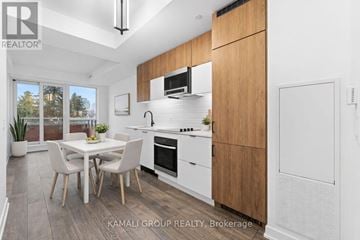 Richmond Hill (South Richvale) condo for rent - A modern kitchen with a dining table and chairs.
