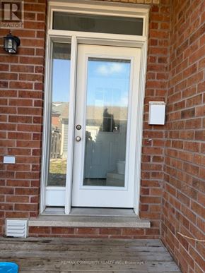 Markham (Cornell) townhouse for rent - A white door with a glass window is set in a brick wall.
