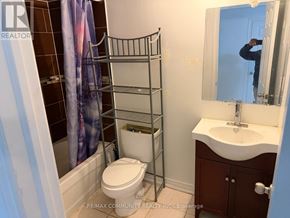 Markham (Cornell) townhouse for rent - A staircase with a white wall and a red jacket hanging on the railing.