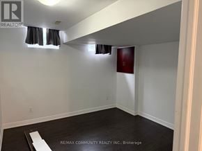Markham (Cornell) townhouse for rent - A kitchen with a stove top oven, microwave, sink, and cabinets.