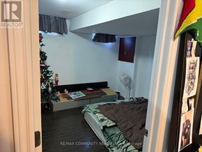 Markham (Cornell) townhouse for rent - A bedroom with a bed, a Christmas tree, and a fan.