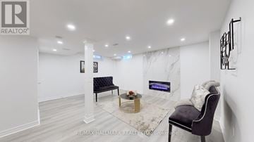 Georgina (Keswick South) apartment for rent - A living room with a black chair and a coffee table.