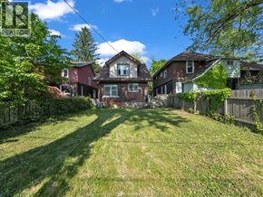 Windsor duplex for rent - A sunny day in a residential area with houses and green lawns.