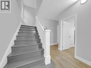 Windsor apartment for rent - A staircase with a white railing and wooden steps.