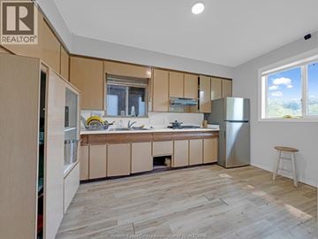 Windsor apartment for rent - A kitchen with wooden cabinets and a refrigerator.