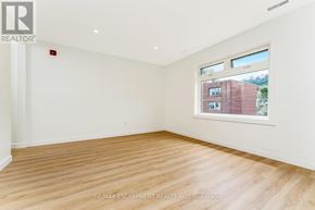 Hamilton (Stinson) multi-family for rent - A room with a window showing a brick building outside.