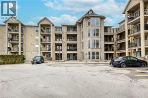 Burlington condo for rent - A black car is parked in the lot of a large apartment complex.