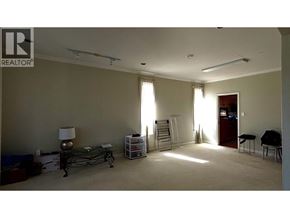 Richmond apartment for rent - A room with a ladder and a table with a lamp on it.