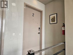 Hamilton apartment for rent - A door with the number 2 on it is in a room with a fire extinguisher on the wall.