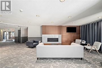 London North (North G) condo for rent - A modern living room with a grey sofa and a wooden accent wall.
