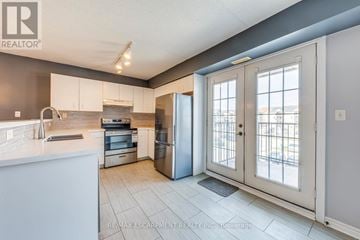 Burlington (Tansley) condo for rent - A kitchen with a white counter top and a refrigerator.