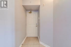 Burlington (Tansley) condo for rent - A white door in a hallway with a brokerage logo on the wall.