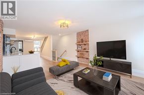 Hamilton apartment for rent - A living room with a grey couch, a black coffee table, and a flat screen TV.