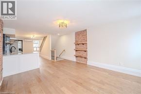 Hamilton apartment for rent - A room with wooden floors and a white wall with a window.