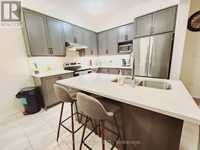 Thorold (Hurricane/Merrittville) apartment for rent - A kitchen with a white counter top and grey cabinets.