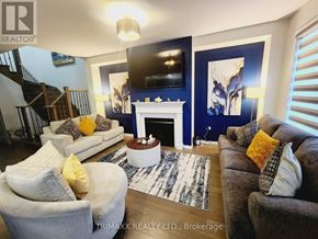 Thorold (Hurricane/Merrittville) apartment for rent - A living room with a fireplace and a television on the wall.