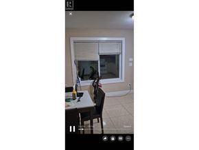 Burnaby apartment for rent - A room with a table, chairs, and a window with blinds.
