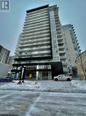 Ottawa condo for rent - A tall building with a sign that says "REALTOR" in front of it.