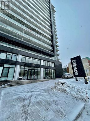 Ottawa condo for rent - A snowy scene in front of a building with a sign that says "BOWERY".