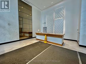 Ottawa condo for rent - A reception area with a carpeted floor and a wooden bench.