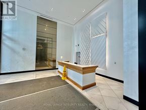 Ottawa condo for rent - A reception area with a wooden counter and a glass door.