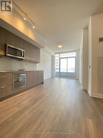 Toronto (Henry Farm) condo for rent - A spacious kitchen with wooden flooring and a modern design.