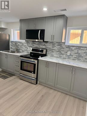 Toronto (Humber Summit) apartment for rent - A kitchen with a stove top oven and a microwave.