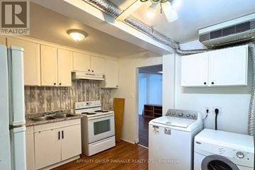 Kawartha Lakes (Lindsay) apartment for rent - A small kitchen with a washing machine and dryer in it.