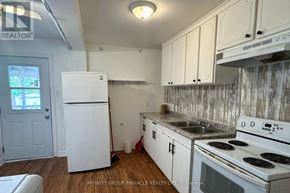 Kawartha Lakes (Lindsay) apartment for rent - A kitchen with white appliances and cabinets.
