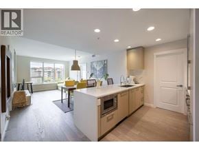 Vancouver apartment for rent - A modern kitchen with wooden cabinets and a white island.